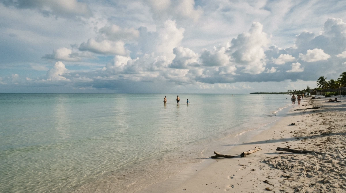 Shallow clear water off a Holbox beach in late afternoon, clouds building over the sea
